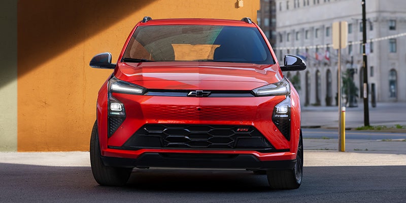 The 2027 Chevrolet Bolt displayed, highlighting its compact shape and electric vehicle characteristics in a scenic setting.